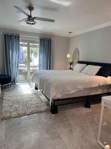 a bedroom with a bed and a ceiling fan at Newly Renovated Villa with Hot Tub in Fort Lauderdale