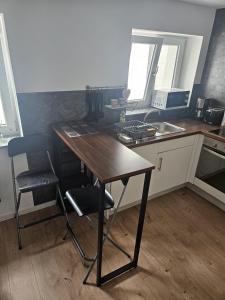 a kitchen with a wooden table and a table and chairs at Easy Flat in Aachen