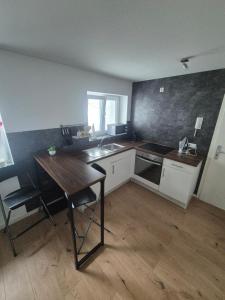 a kitchen with a sink and a table in it at Easy Flat in Aachen