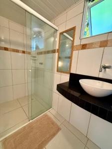 a bathroom with a sink and a glass shower at Pousadinha in Ilha do Mel +41 photos