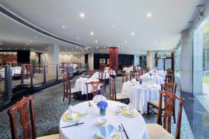 a restaurant with tables and chairs with white table cloth at DoubleTree by Hilton Shanghai Pudong in Shanghai