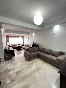 a large living room with a couch and a table at Corniche Casablanca in Casablanca