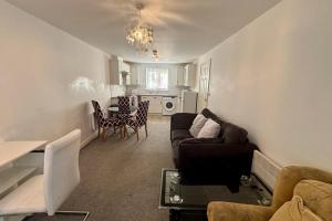 a living room with a couch and a table at 2 Bed Apartment-Sleeps 4-Free Parking in Monmore Green