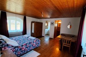 a bedroom with a bed and a wooden ceiling at Masseria Ramello in Cadenazzo