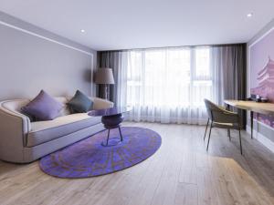 a living room with a couch and a table at Mercure Xi'an Downtown in Xi'an