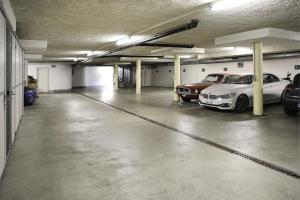 un parking avec deux voitures garées à l'intérieur dans l'établissement VISIONAPARTMENTS Bellariastrasse - contactless check-in, à Zurich