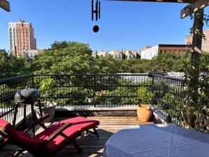 a patio with a table and chairs on a balcony at Luxurious bedroom in New York
