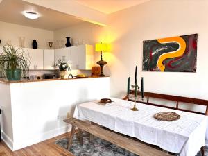 a dining room with a table and a kitchen at Luxurious bedroom in New York