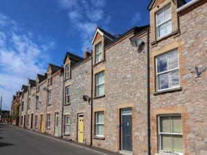 a row of brick buildings on a street at Lenny's Place in Saint Decumans