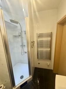 a bathroom with a shower with a glass door at Exclusives Apartment in Essen Rüttenscheid in Essen