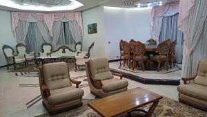 a room with chairs and a table and a table and chairs at Azur villa in Sfax