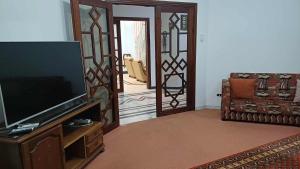 a living room with a flat screen tv and a couch at Azur villa in Sfax