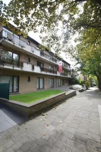 an empty street in front of a building at Budget Flats Brussels in Brussels