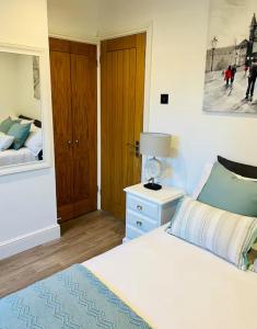 a bedroom with a bed and a lamp on a table at Cozy Private Access Room in Moffat