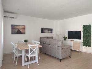 a living room with a couch and a table and a television at La Placeta in Vara de Rey