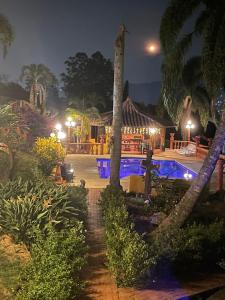 a resort with a swimming pool at night at Finca Hotel Villa Camila in Copacabana