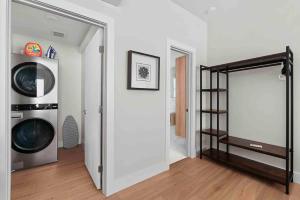 a room with a washer and dryer next to a door at Superb location steps to DT and UT in Austin
