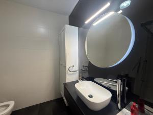 a bathroom with a white sink and a mirror at Estrecha de San Andres in A Coruña +9 photos