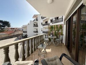 a balcony of a building with chairs and a table at Fabulous Terrace 1 - Checkinhome in Cascais +21 photos