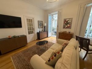 a living room with a couch and a flat screen tv at Estrecha de San Andres in A Coruña