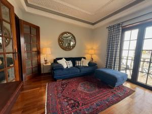 a living room with a blue couch and a rug at Fabulous Terrace 1 - Checkinhome in Cascais