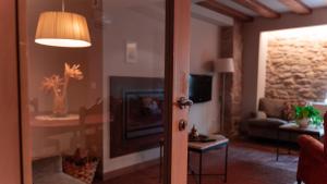a room with a living room with a fireplace at Hotel El Cerco in Puente la Reina