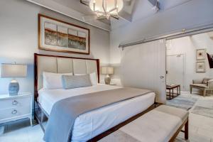 a bedroom with a large bed and a chair at Parker's Collection Unit 7 in Savannah +25 photos