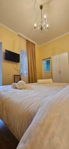 a bedroom with a large bed with two towels on it at Queen Tamar Mefe 71 in Kutaisi