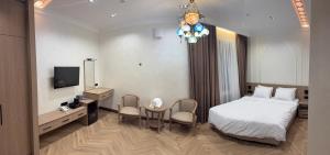 a hotel room with a bed and a desk and a television at Oldtown1111 in Samarkand