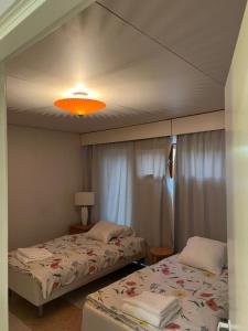 - une chambre avec deux lits et une lumière dans l'établissement Casa Peipponen, à Kuopio