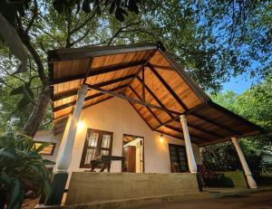 a small house with a large roof at Verdant Hill Villa in Tangalle