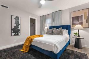 a bedroom with a blue bed with a yellow blanket on it at Steps away from Downtown Restaurants and Bars - King Bed in Austin +22 photos