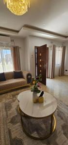 a living room with a couch and a table at Dunslim Apartments in Lusaka