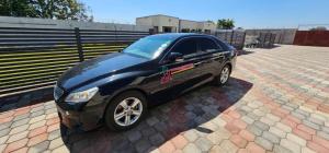 a black car parked in a parking lot at Dunslim Apartments in Lusaka