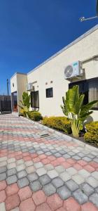 a brick walkway in front of a building at Dunslim Apartments in Lusaka