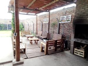 Un patio con bancos y una chimenea y una pared de ladrillos. en Meraki, en Santa Lucía