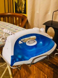 a blue and white iron sitting on top of a table at Guesthouse 20 in Banting +6 photos