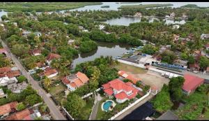 an aerial view of a town with a river at Cs white house negombo in Negombo
