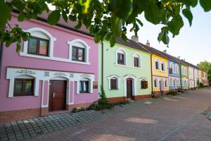 a row of colorful houses on a street at Sklípek Nechory in Prušánky