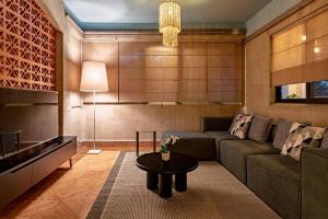 a living room with a couch and a table at Majestic Colonial Villa Private Pool Jacuzzi and Gardens in Ocotepec