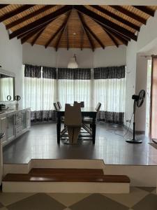a dining room with a table and a microphone at Cs white house negombo in Negombo