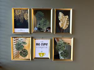 a group of framed pictures on a wall at Chic Homestay with Mini Cafeteria at Gamuda Garden in Rawang