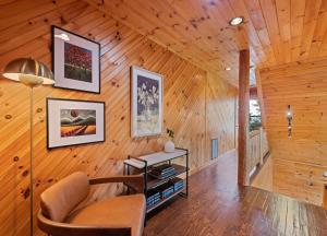 a living room with a chair and a table at Mid-Century Decor Cabin with Stunning Views in Clyde