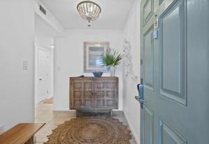a hallway with a blue door and a rug at Jetty East, Paradise Palms, Sleeps 4, Pool Private Beach in Destin +35 photos