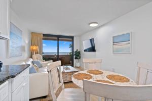 a kitchen and a living room with a table at Jetty East, Paradise Palms, Sleeps 4, Pool Private Beach in Destin