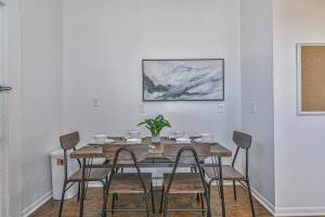 a dining room with a wooden table and chairs at 3 Room 2nd-Floor Suite near Beach, Pier, Strand in Galveston