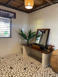 a bathroom with a sink and a mirror on the wall at Le Pariskomba Lodge in Anjiabe