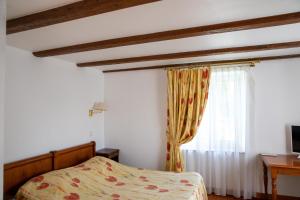 a bedroom with a bed and a window at La ferme du Franz in Diefmatten