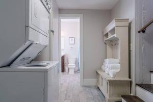 a white kitchen with a sink and a toilet at Historic and charming duplex in desirable midtown, close to the beach and strand in Galveston +72 photos