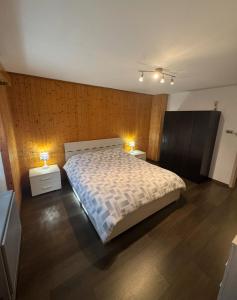 a bedroom with a large bed and two night stands at Casa Angelica in Quinto